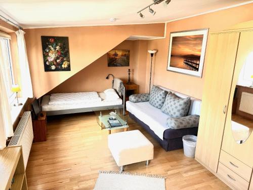 a living room with a couch and a table at Apartment to Düsseldorf - near Airport DUS - Trade Fair - Arena in Düsseldorf