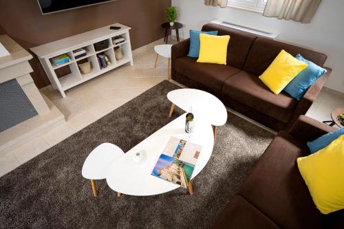 a living room with a couch and a table at Hvaretta Villas in Stari Grad
