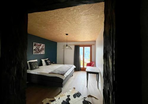 a bedroom with a bed in a room with blue walls at La Forge de Diogne - luxury B&B and apartments in Crans-Montana