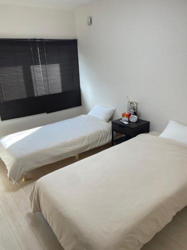 Postel nebo postele na pokoji v ubytování Clover House 大人数向け一軒家