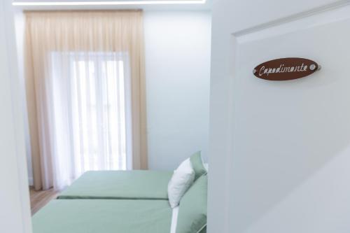 Postel nebo postele na pokoji v ubytování Iannò Napoli Rooms