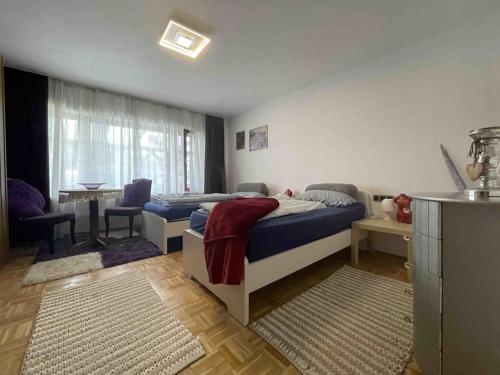 a bedroom with a bed and a living room at DUG101 - Große Monteurwohnung in Duggendorf