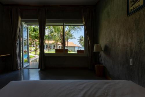 Postel nebo postele na pokoji v ubytování Cosian Bay Phu Quoc Resort