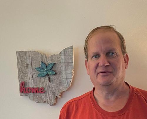 a man is standing next to a heart on a wall at Gahanna Ranch-Tastic 3-bedroom recently renovated Aug 2024 in Gahanna
