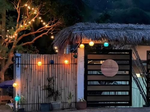 a gate with lights in front of a fence at Apong Martina's Guest House La Union in Lacong