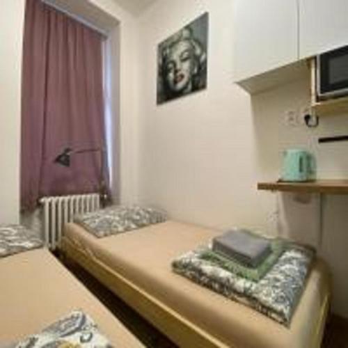 a small room with two beds and a window at MINATO Apartments Ostrava center in Ostrava
