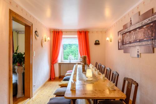a long dining room with a long table and chairs at maison de vacances chez louis in Sondernach
