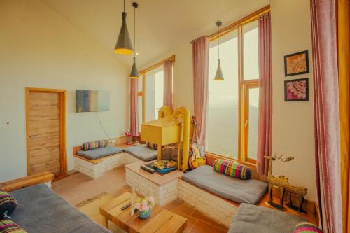 a living room with two couches and a table at Revaant Retreat in Rāmgarh