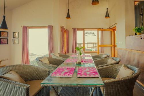 a dining room with a table and chairs at Revaant Retreat in Rāmgarh