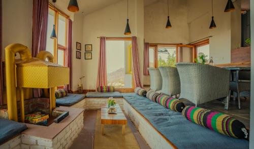 a living room with a couch and a fireplace at Revaant Retreat in Rāmgarh