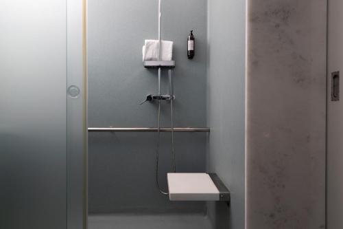 a small bathroom with a toilet and a sink at Hotel Rali Viana in Viana do Castelo