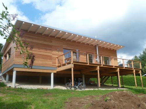 a large wooden house with a large deck at WaldNur in Neureichenau