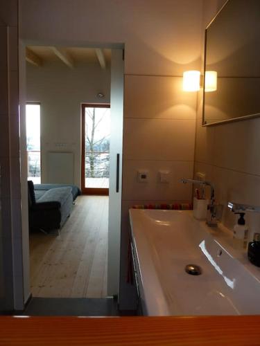 a bathroom with a tub and a bed in a room at WaldNur in Neureichenau