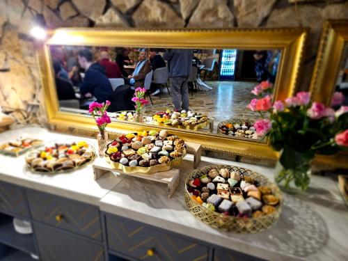 a buffet of food in front of a mirror at Hotel Galicja SPA Wieliczka in Wieliczka