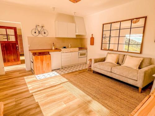 a living room with a couch and a kitchen at Lisbon Countryside - Serenity Near the City in Calhandriz