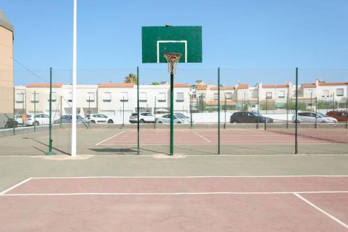 an empty basketball court with a basketball hoop at BAJO primera línea playa, Retamar, Cabo de Gata in Retamar