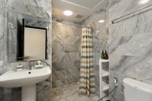 a bathroom with a sink and a mirror at 1bdr Apartment Naiharn Beach Condo by CapitalPro in Phuket Town