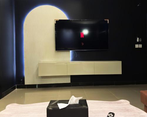 a room with a flat screen tv on a wall at Regal Suite by StayMehman in Rawalpindi