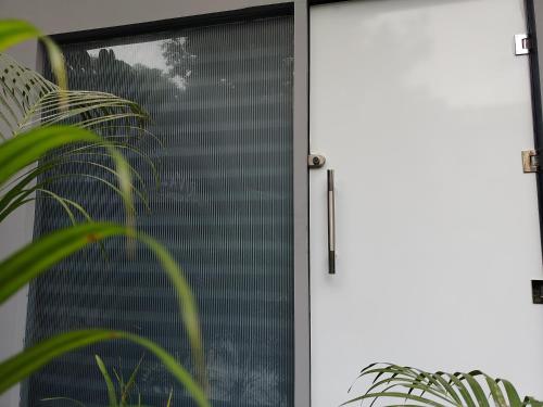 a sliding glass door with a window at Rivaz Hotel And Restaurant in New Delhi