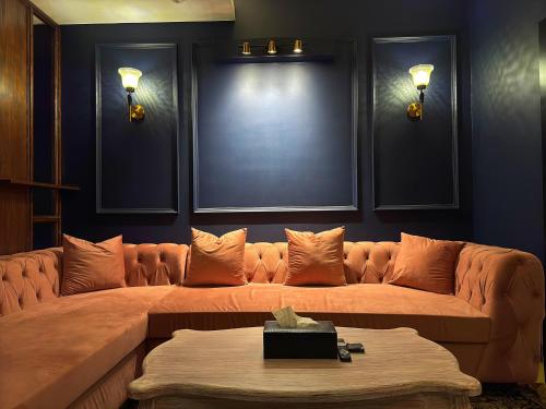 a living room with a large couch in a room at Regal Suite by StayMehman in Rawalpindi