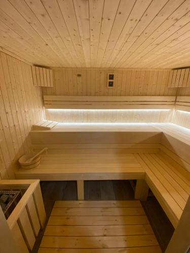 a small wooden sauna with a bench in it at Abbázia Club Hotel Kék in Keszthely