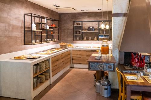 a kitchen with a counter with food on it at Hotel Columbia in Marina Romea
