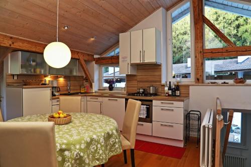 a kitchen and dining room with a table in a house at Villa Lageder in Sarntal