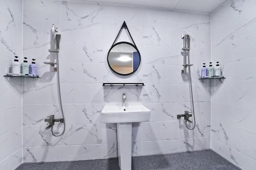 a bathroom with a sink and a mirror on the wall at sweet hotel in Gimcheon