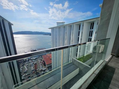 a balcony of a building with a view of the water at Summer Studio Apartment at Kota Kinabalu City Centre in Kota Kinabalu