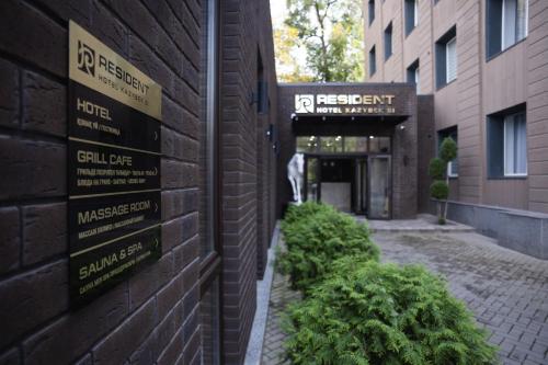 a brick building with signs on the side of it at Resident Hotel Kazybek Bi in Almaty