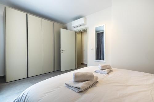 a bedroom with a large bed with two towels on it at Dolce Pieta' Penthouse in Pieta