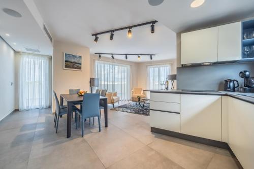 a kitchen and dining room with a table and chairs at Dolce Pieta' Penthouse in Pieta