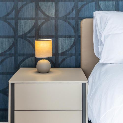 a bedside table with a lamp on it next to a bed at Dolce Pieta' Penthouse in Pieta