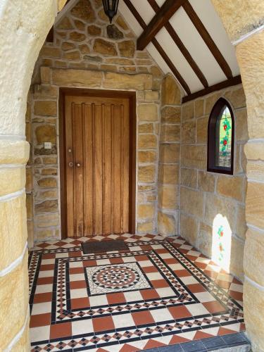 a room with a tiled floor next to a door at The School House, Ironbridge in Ironbridge