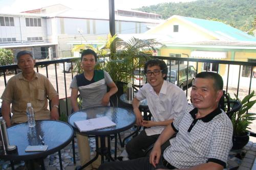 a group of people sitting at tables on a balcony at Moatoga Hotel in Apia