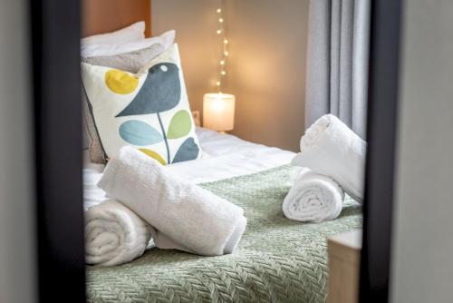 a bedroom with a bed with towels on it at Lodge No 83 - Stewart's Resort Cameron in St. Andrews