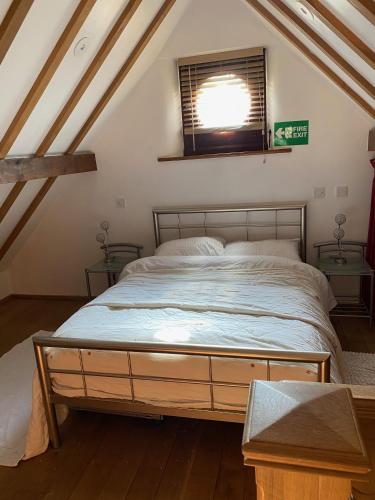 a bedroom with a large bed in a attic at The School House, Ironbridge in Ironbridge