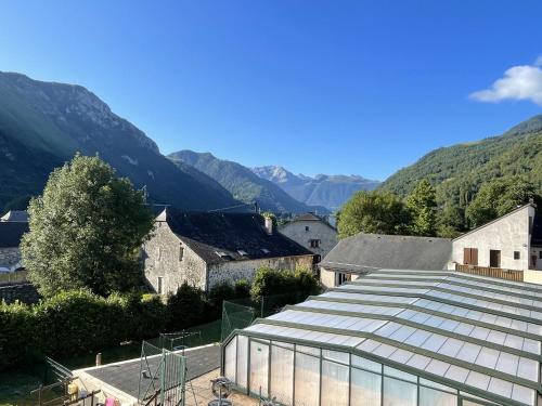 a group of buildings with mountains in the background at Souleih d Ossau 203 in Bielle