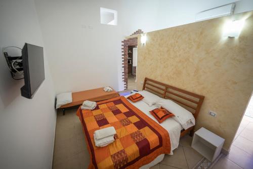 a bedroom with two beds and a flat screen tv at Apulia lux in Taranto