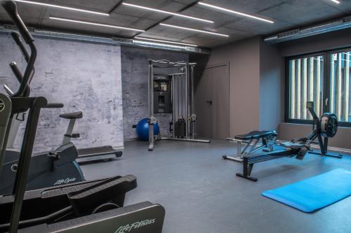 a gym with treadmills and machines in a room at Vip Residences Andorra in El Tarter