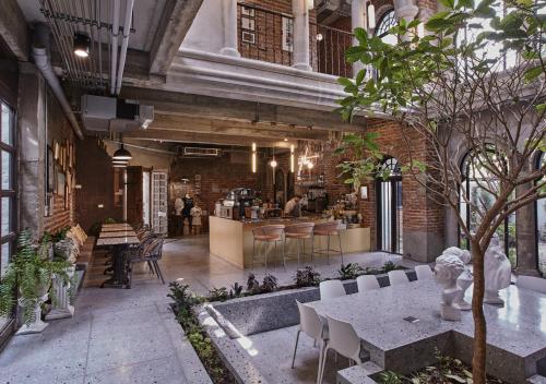 a room with a table and chairs in a building at Cataleya Estate Boutique Bed & Breakfast in Bangkok