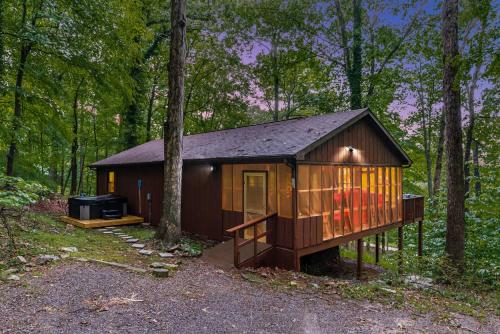 a small cabin in the middle of the woods at River Cabin w Great Views, Screened Porch & Fire Pit in Great Cacapon