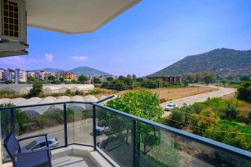 a balcony with a view of a street and mountains at Port Selene Otel in Kışlabucağı