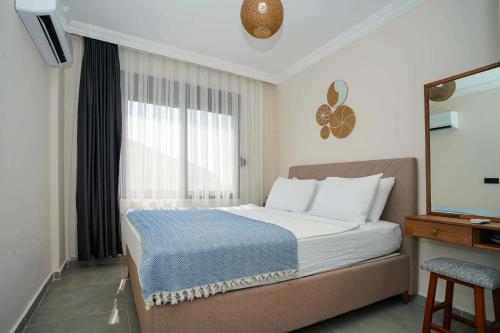 a hotel room with a bed and a window at Port Selene Otel in Kışlabucağı