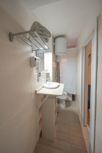 a bathroom with a sink and a toilet at Lighthouse Taranto in Taranto