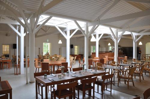 a dining room with tables and chairs in a building at Vidago Palace in Vidago