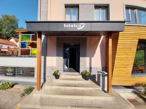 a entrance to a building with a sign on it at Hotel Fabrica in Liberec