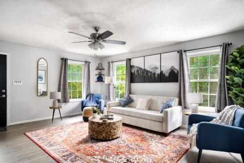 a living room with a couch and a ceiling fan at Cabin w hot tub & fire pit Shenandoah River in Luray