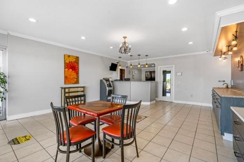a kitchen and dining room with a table and chairs at Budgetel Inns & Suites Augusta Downtown 706-945-1238 in Augusta