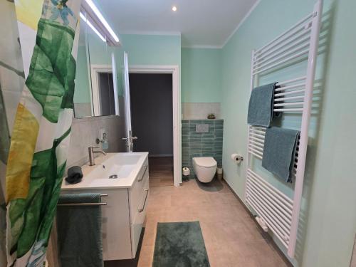 a bathroom with a sink and a toilet at HR Haus unter den Linden in Coesfeld